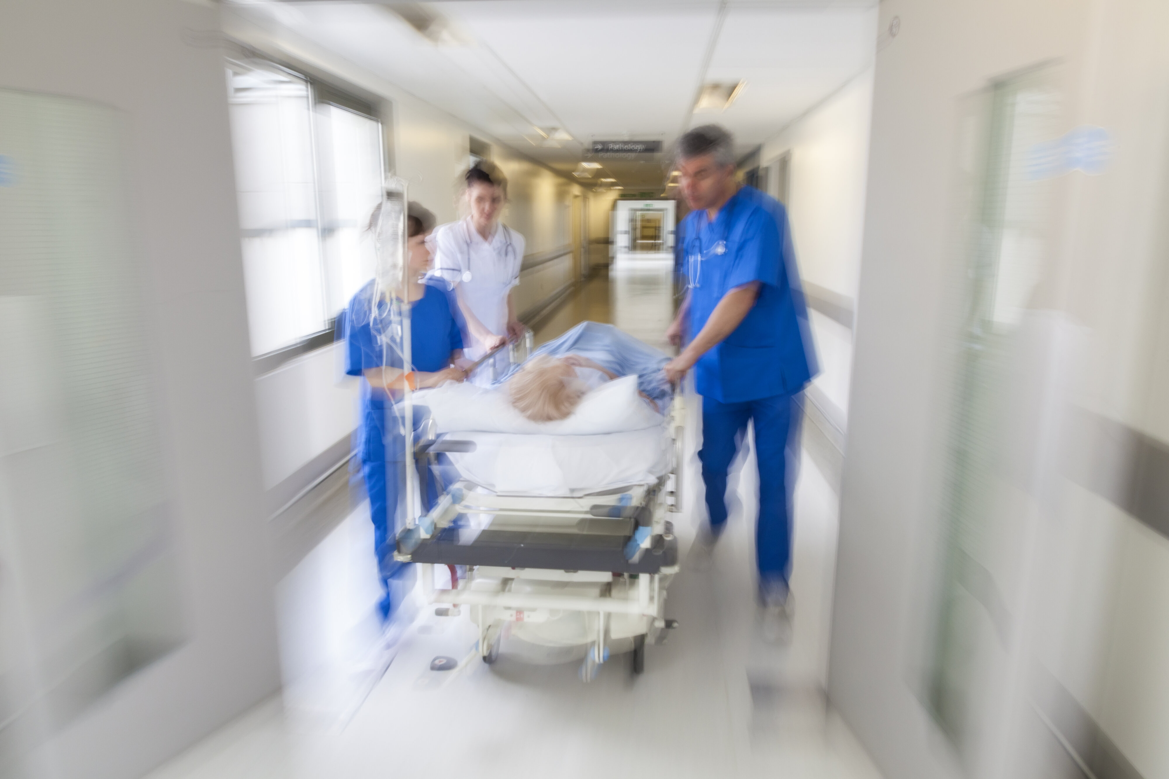 Doctors accompanying a patient on a stretcher