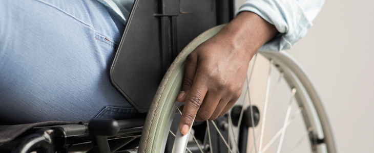 partial view of a person sitting in wheel chair