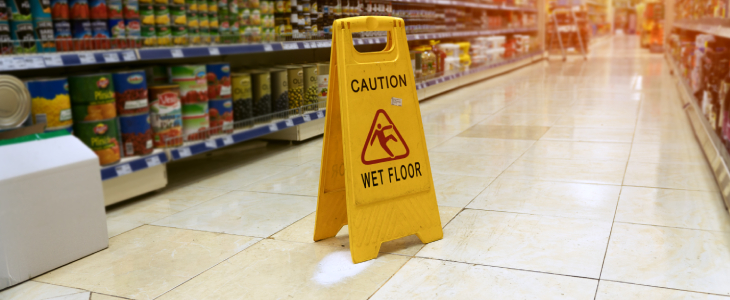 Caution Wet Floor sign in an aisle of a grocery store