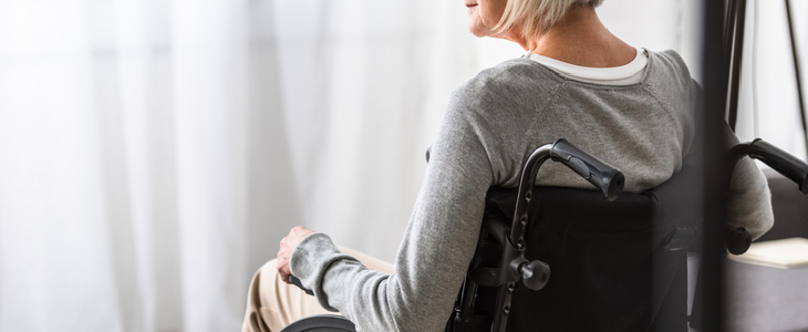 Woman sitting on a wheelchair and looking out into the distance