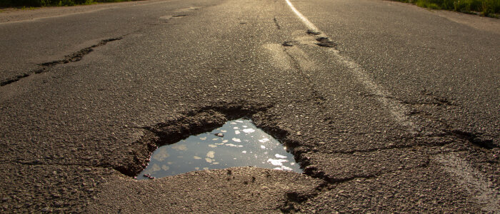 Crack in the road that can cause vehicle damage
