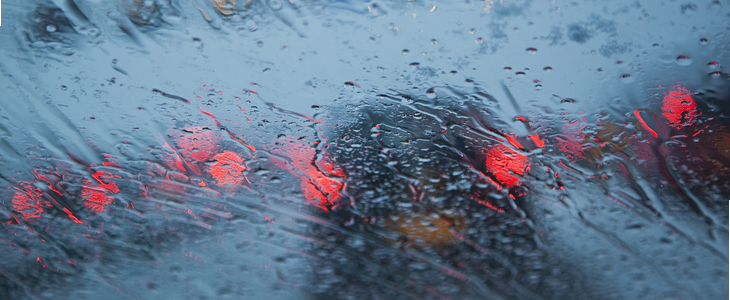 Car driving in heavy rainfall