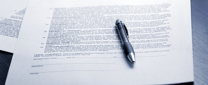 A contract document with a pen on the table