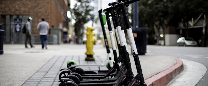 Electric scooters on the sidewalk of a street