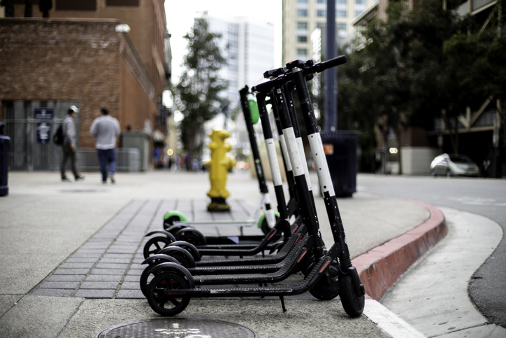 Electric scooters on the sidewalk of a street