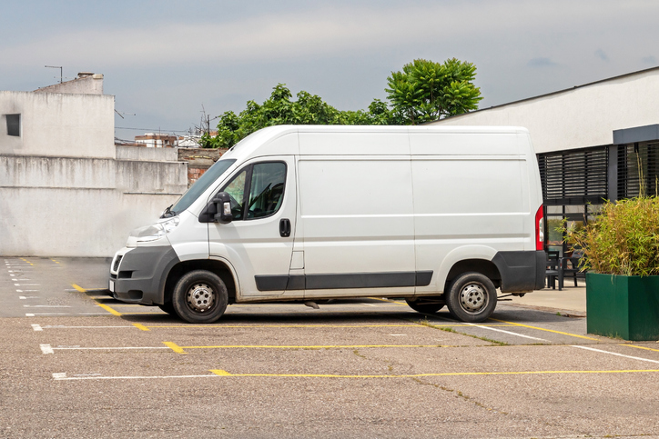 White delivery van parked in a lot