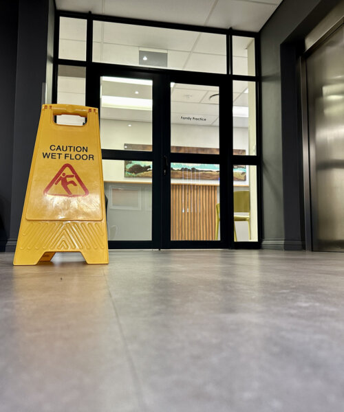 A wet floor sign in an office space.