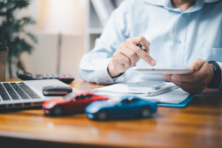 Man calculating car insurance payments