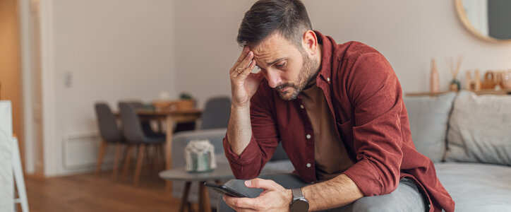 Stressed man sitting on a couch