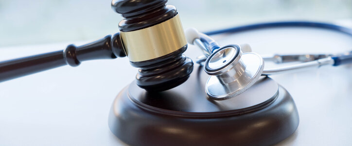 A table with a gavel and stethoscope