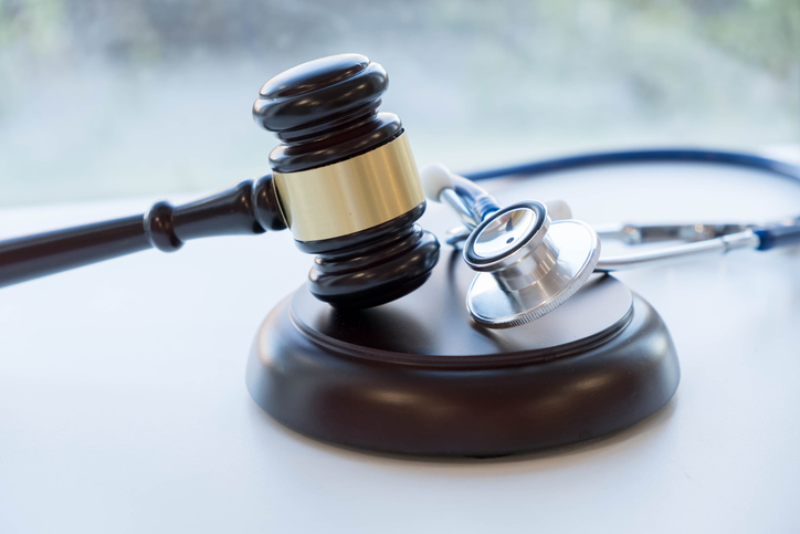 A table with a gavel and stethoscope