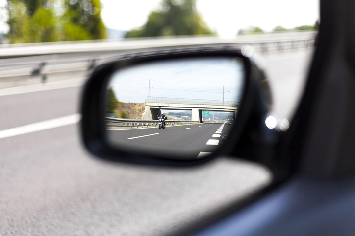 Man looking out his side-view mirror