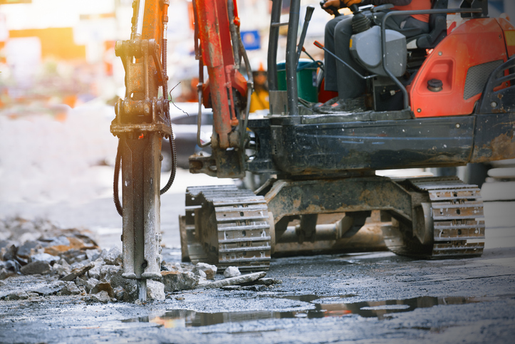 Construction machine drilling on a site.