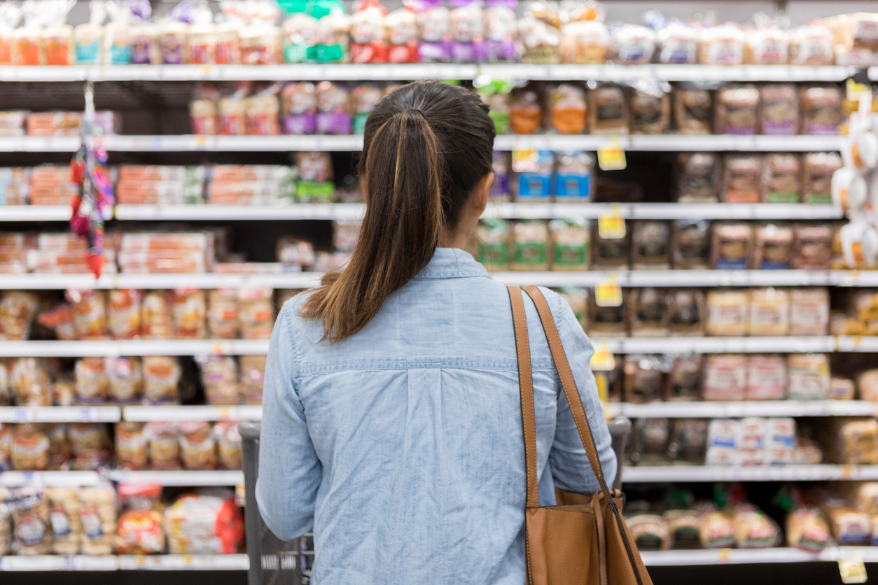 Shopper looking at products on a shelf.