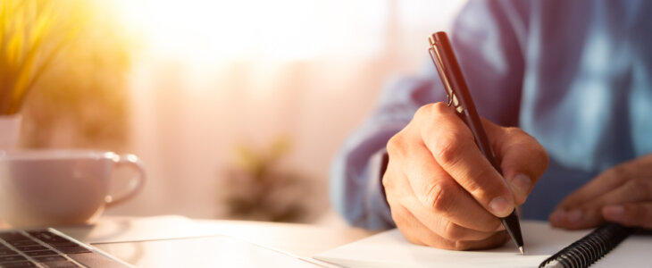 Man writing on a journal