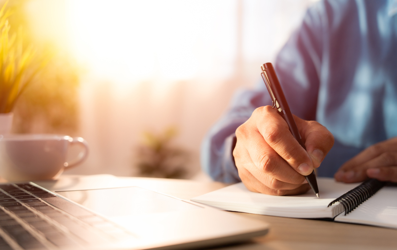 Man writing on a journal