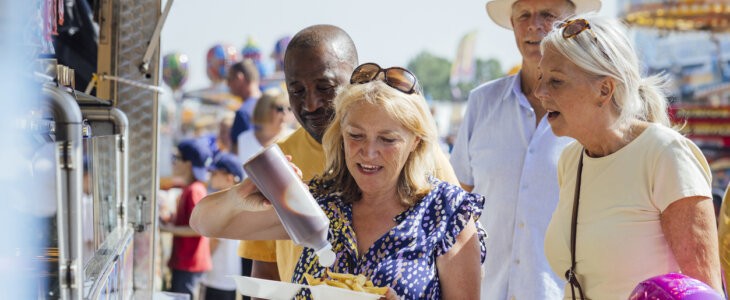 Side view of senior adults visiting an outdoor event