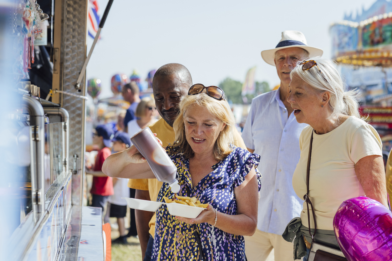 Side view of senior adults visiting an outdoor event