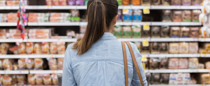 Shopper looking at products on a shelf.